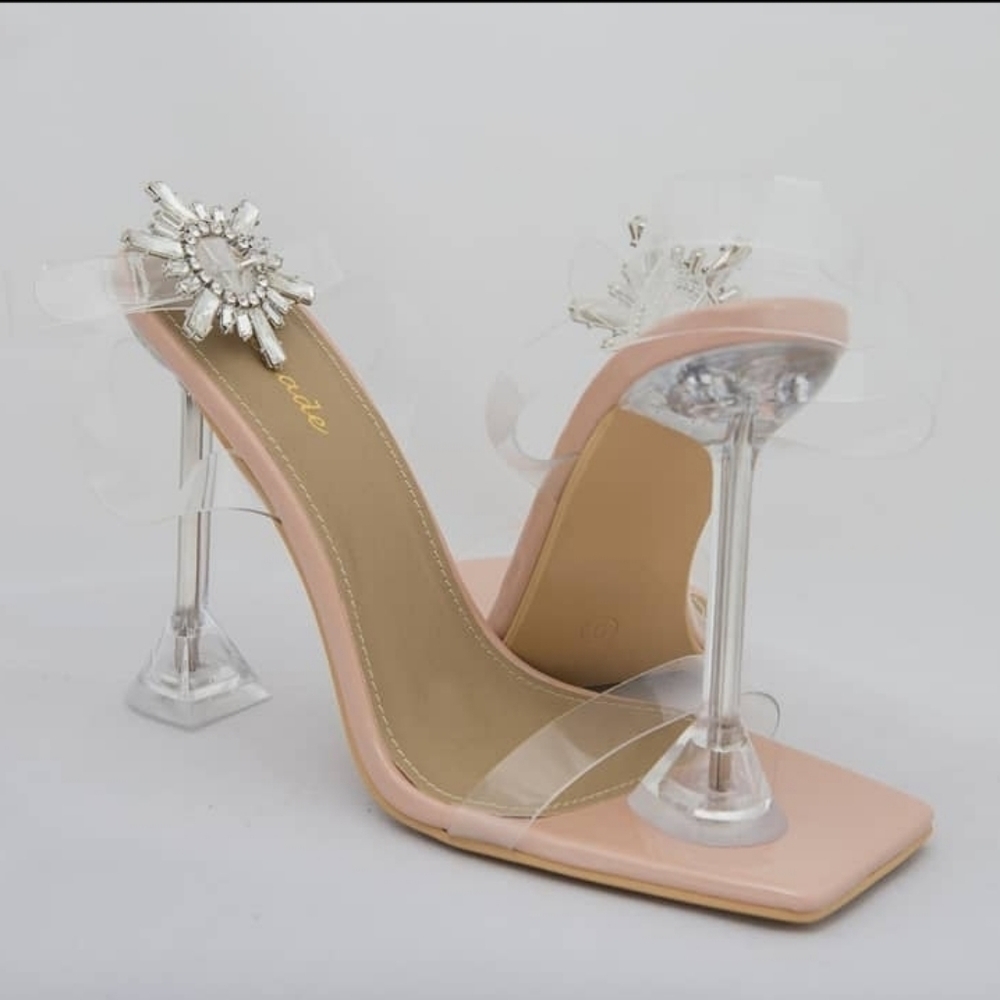 Clear heel with strap and starburst buckle.